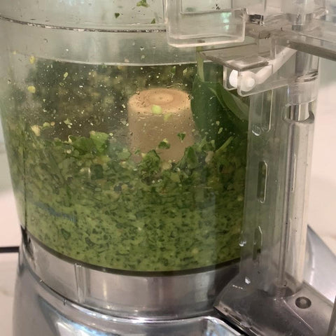 Blending pesto ingredients together.