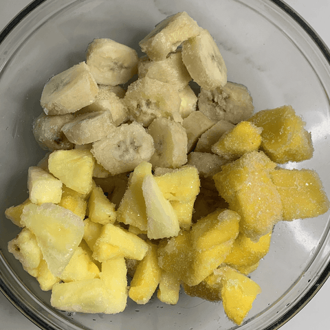 Frozen bananas and pineapples in a bowl