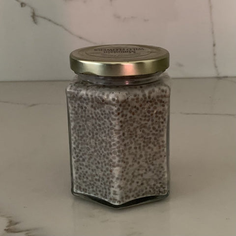 Chia seeds with oat milk and agave left in a glass container overnight.