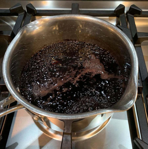 Elderberry syrup in saucepan