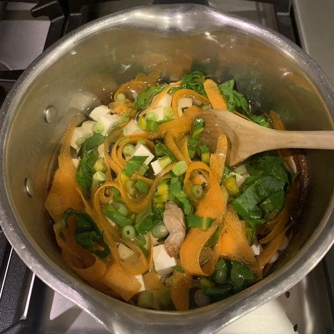 Miso soup preparation in a pot.