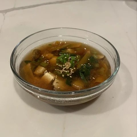 A bowl with miso soup ready to be served.