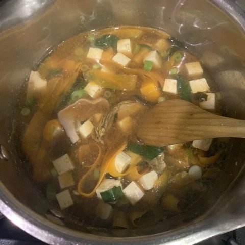 simmering and stiring all ingredients. Tofu, chard, kale, mushrooms.