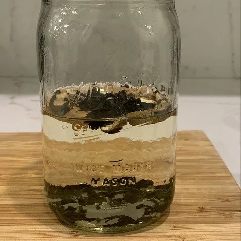 Soaking mushrooms in a bottle as part of the miso soup recipe instructions.