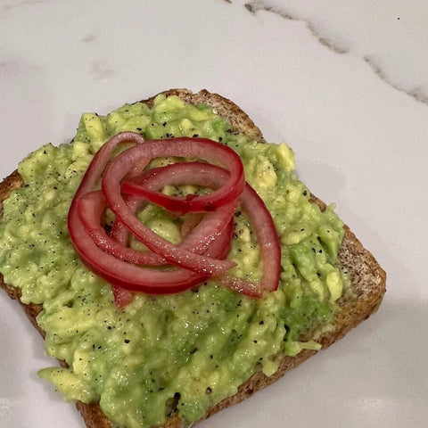 Bread toast with avocado and pickled red onions