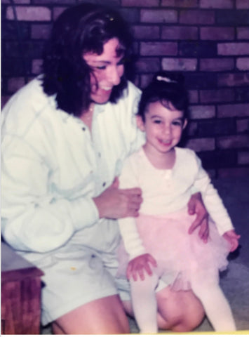 Little girl in ballerina outfit with mom 