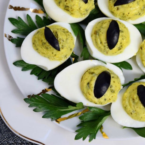Avocado Deviled Eggs with black olives and parsley 