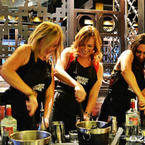 A group of women taking a mixology class