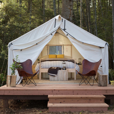 Glamping in style with elevated tent, leather chairs and full-sized bed