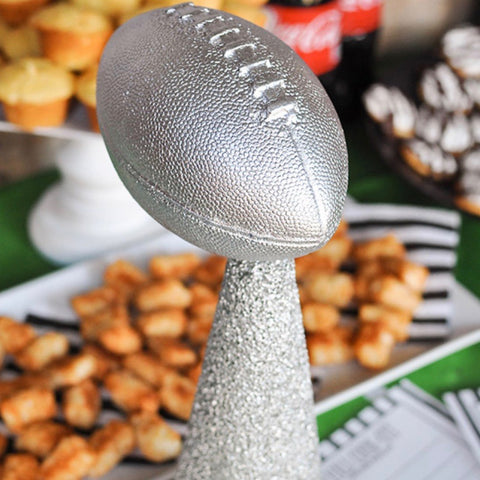 Silver metallic football trophy on glitter stand