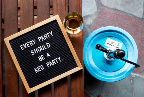 Blue rosé keg and letter board with saying for fun outdoor party.