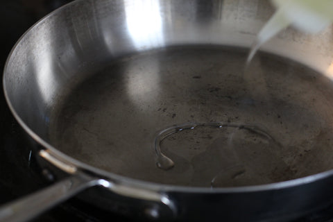 adding oil to hot pan