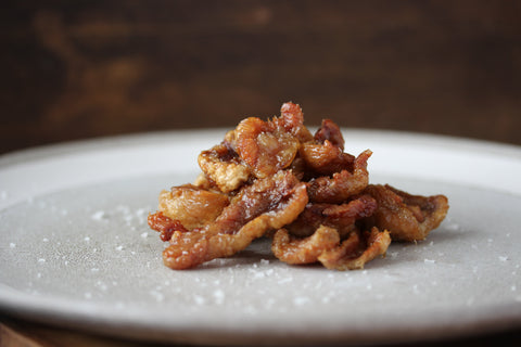 crispy duck skin on plate sea salt