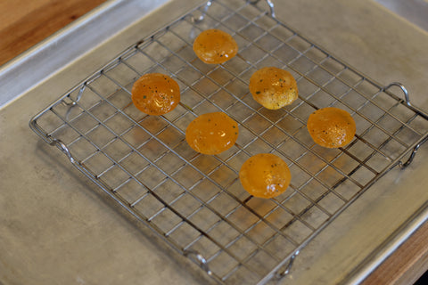 egg yolks on a baking rack ready to be dehydrated