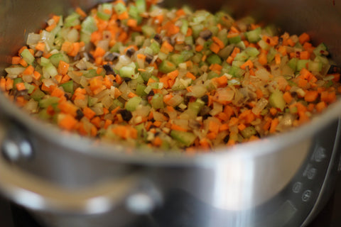 saute vegetables and mirepoix in pot