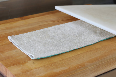 towel placed under cutting board stop from slipping