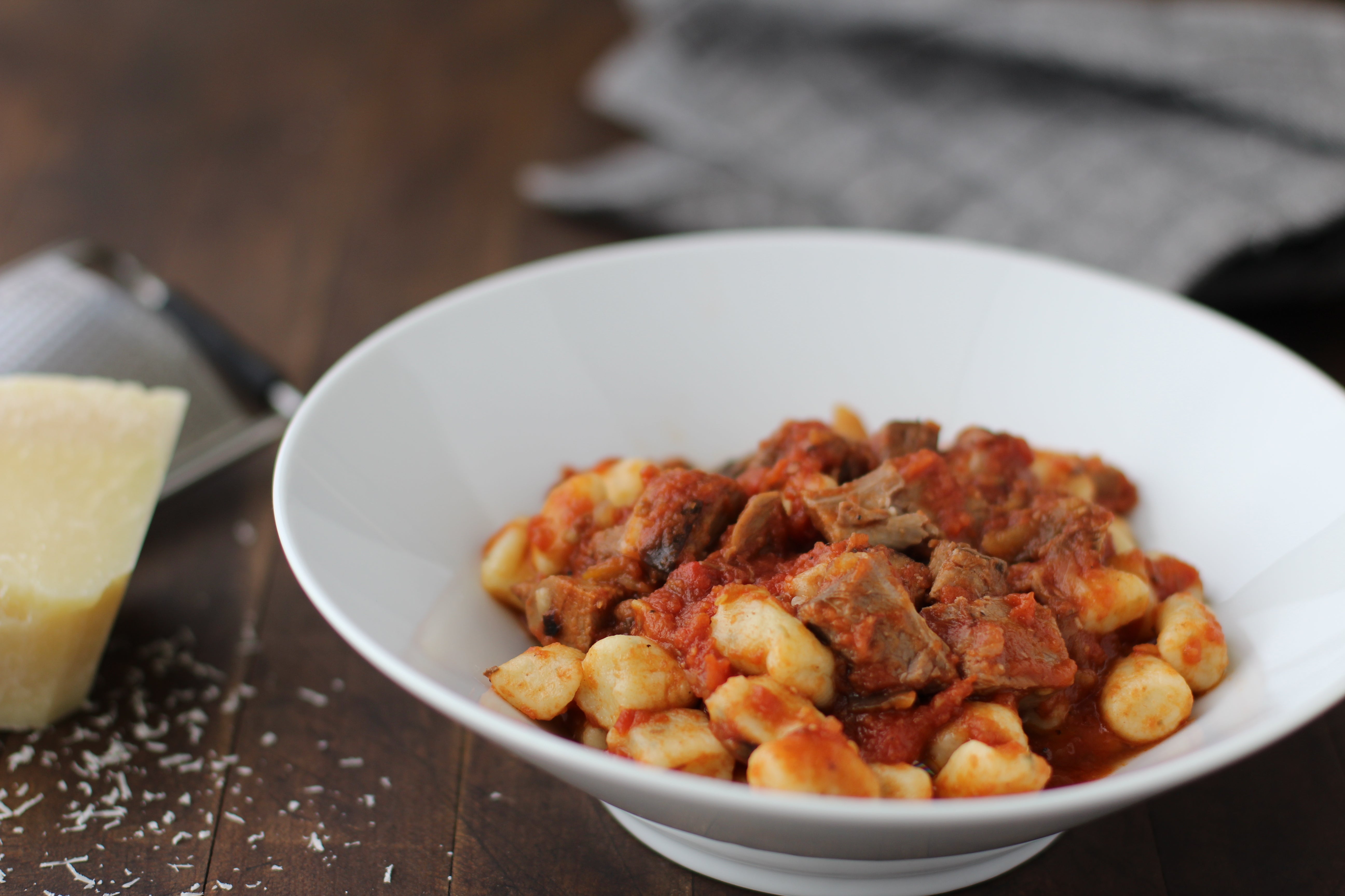 braised lamb shoulder gnocchi San Marzano tomato sauce grated pecorino cheese  