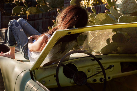 The art of doing nothing. Sitting on an old car staring off at the clouds daydreaming.