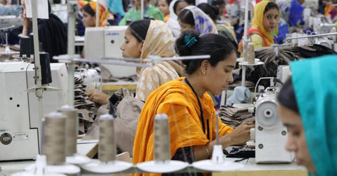 Women working at machines at Fast fashion factory  