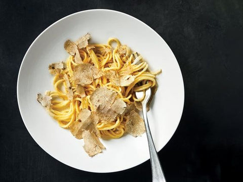 sliced white truffles added into pasta