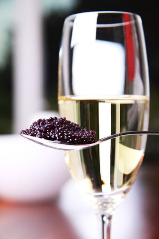 a glass of champagne and caviar 