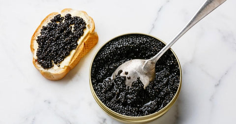 Caviar on bread and next with a cup of caviar