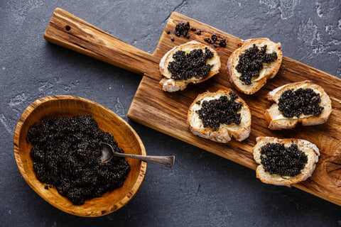caviar with breads and a bowl of caviar