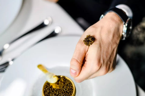 serving caviar on hand 
