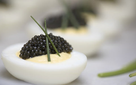some black caviar placed on the hard-cooked eggs