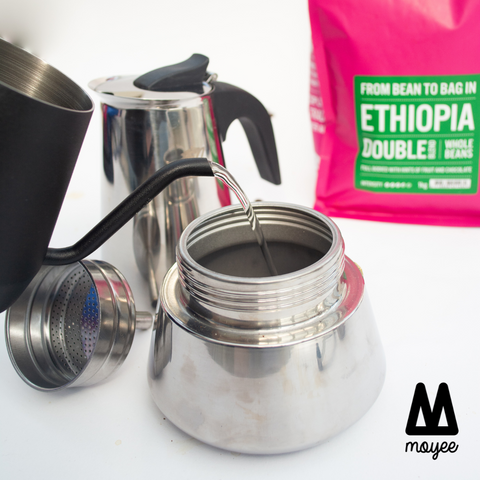 Pour hot water into the bottom of the moka pot until it reaches the valve