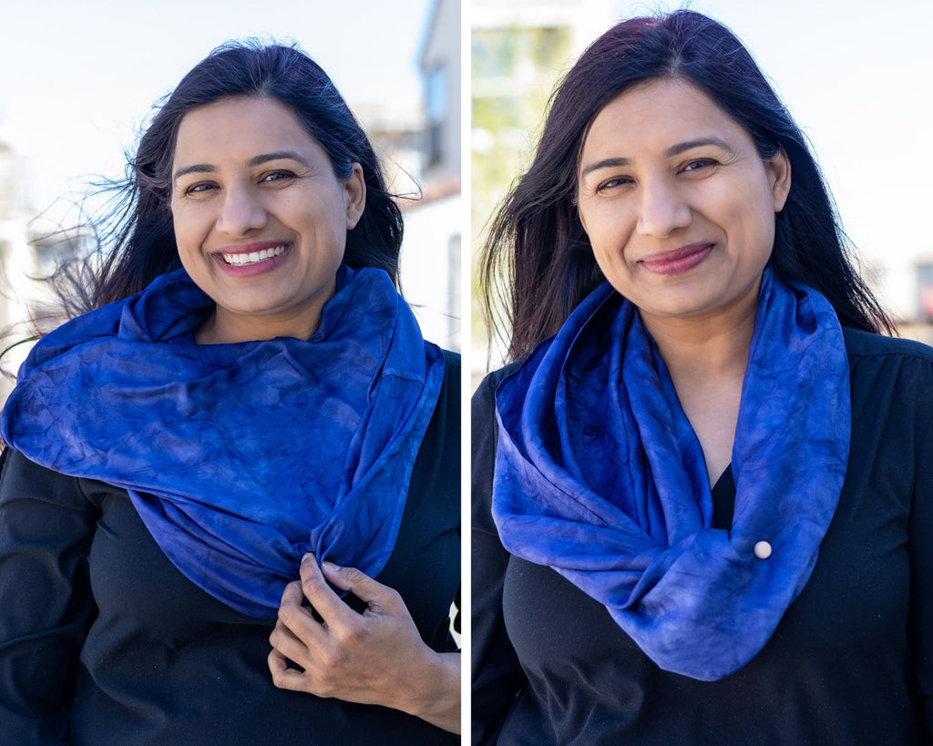 Photo collage of Indian woman with long, dark hair blowing in the wind, wearing a black shirt & Midnight blue silk infinity scarf.  In the first photo she's holding the scarf down with one hand.  In the second photo a magnetic pin clips the scarf to her shirt so the scarf doesn't blow around in the wind.