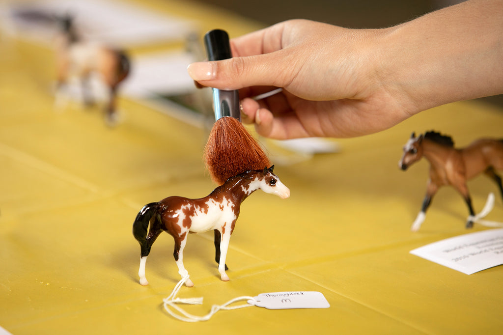 Dusting off Breyer model with a makeup brush