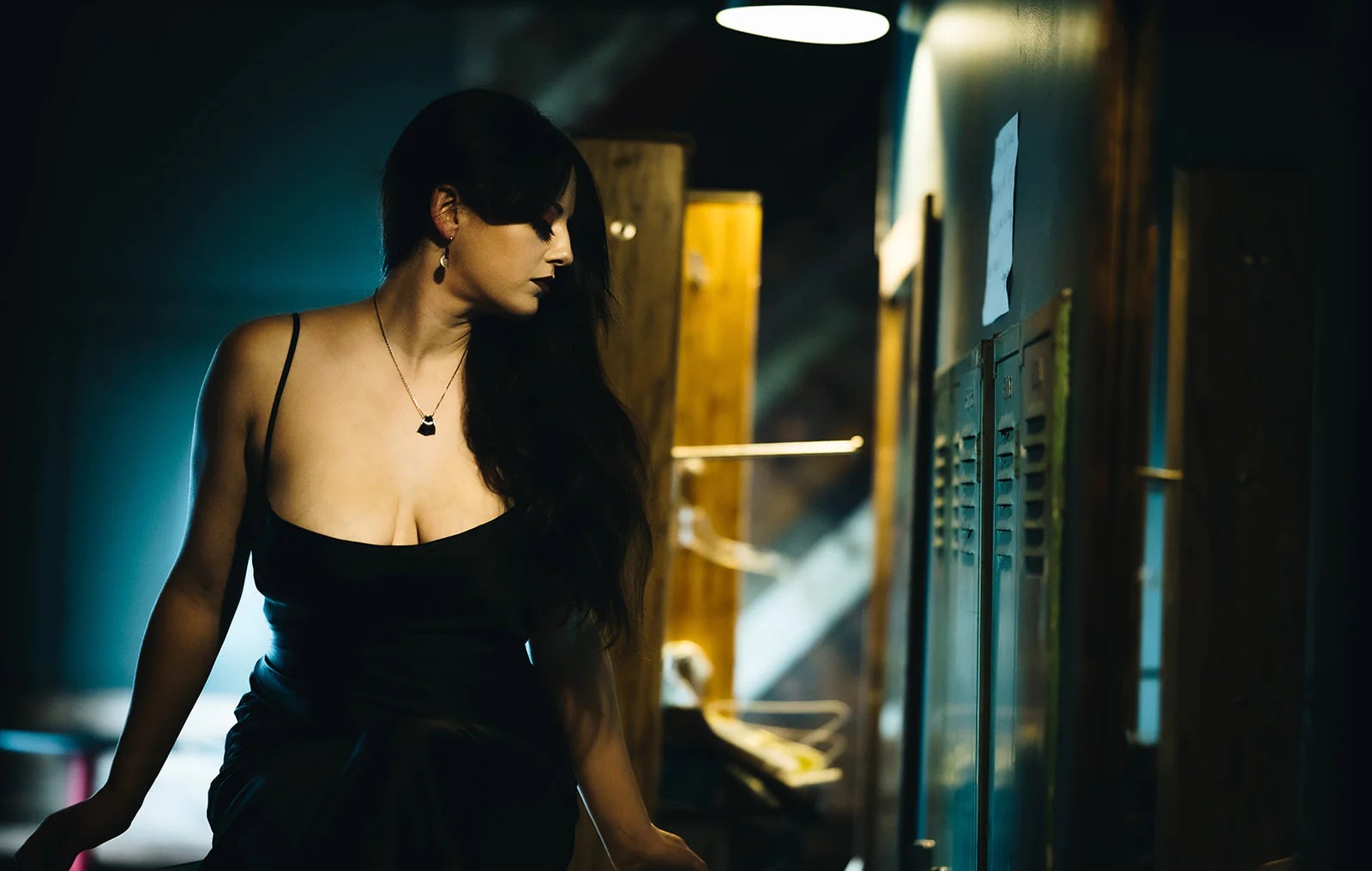 woman wearing jewelry for formal dress including a black pendant necklace and earrings