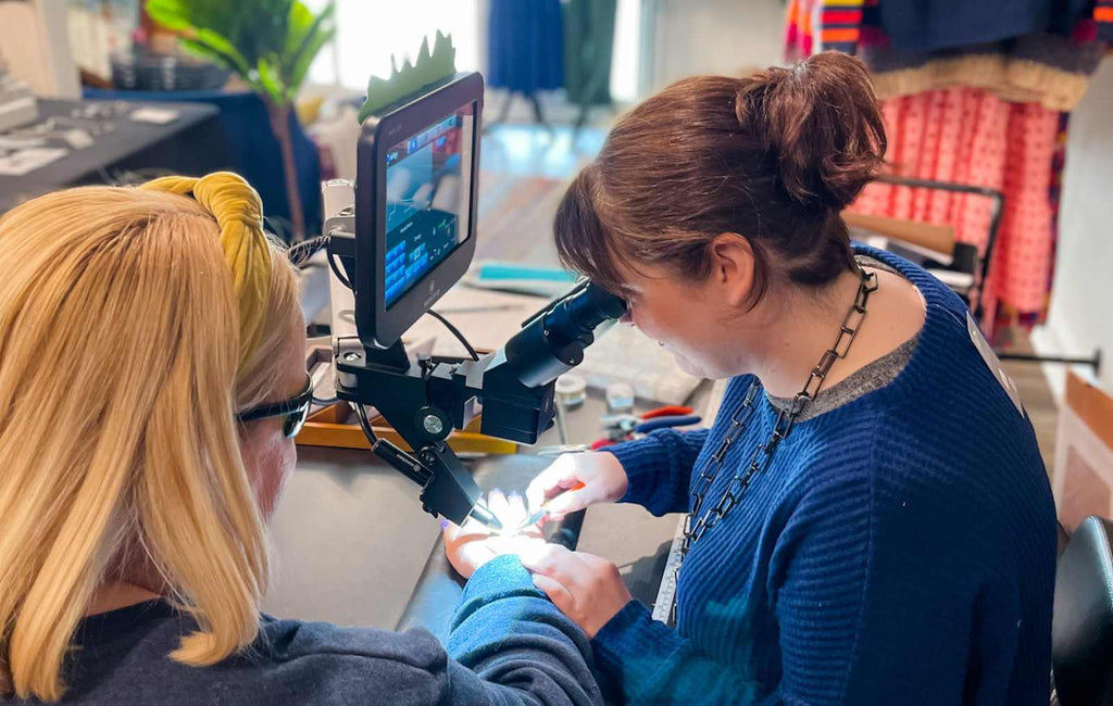 Rebecca Zink of Zink Metals welds a permanent jewelry bracelet on a customer at a recent event in Indianapolis, IN