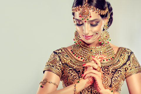 traditional indian jewelry features voluminous gold and precious gemstones