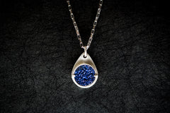 A trendsetting silver gemstone necklace with a bright blue druzy gemstone