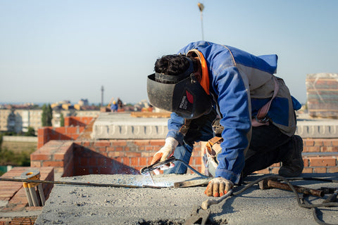 image of a man welding at a construction site
