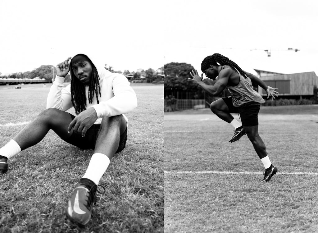 The athlete wearing a LYFTLYFE elite hoodie warming up for his winter run on a soccer field.