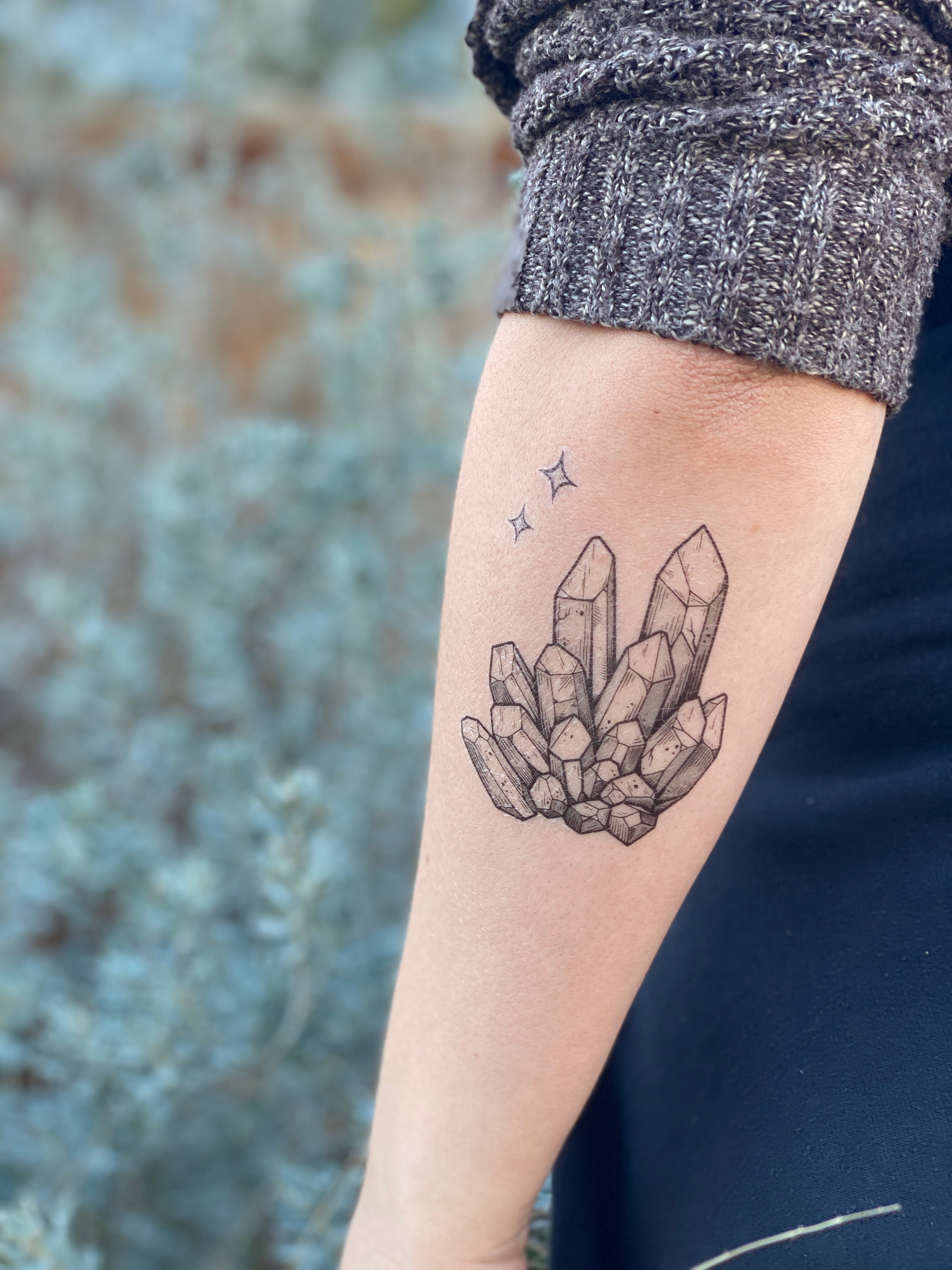 Surrealist handshake duel tattoo on the left inner arm