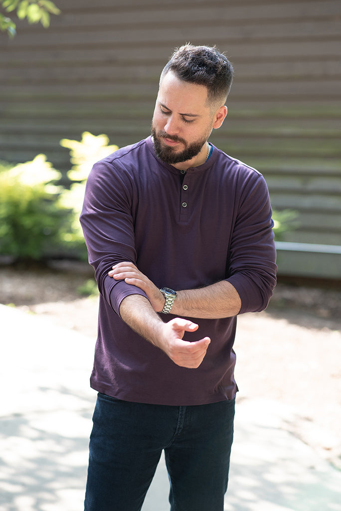 man wearing a purple henley