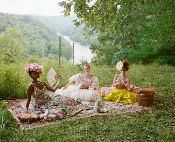 High fashion picnic in countryside with decadent corsets, ruffled dresses and parasols