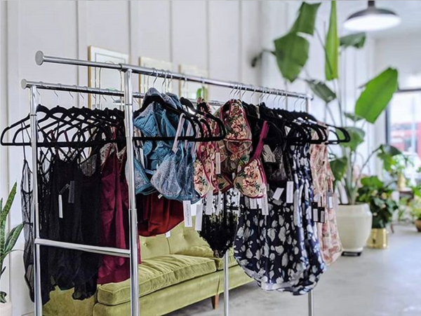 Colorful, designer lingerie on a clothing rack from boudoir photographer Lilac & Fern