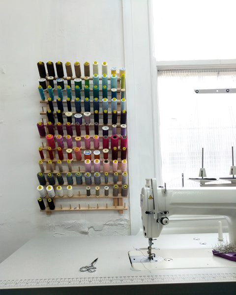 Sewing machine in the corsetmaker studio with colourful thread spools