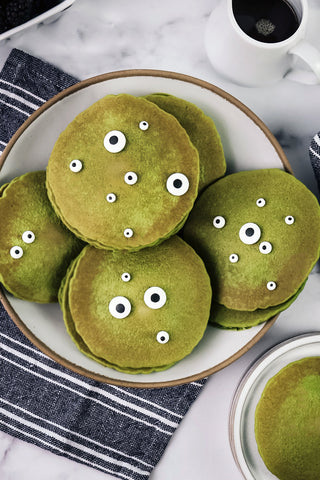 Green matcha pancakes with candy eyes to make monster pancakes