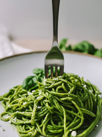 Matcha Pesto on pasta with a fork in the middle