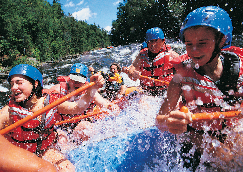 group having fun white water rafting