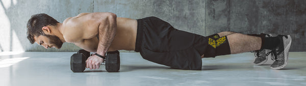 A man does push-ups during weight training.