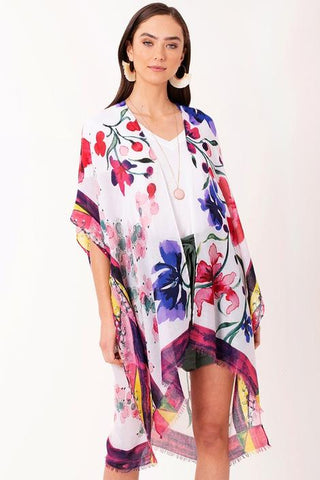 Woman in shorts, tank top and floral print kimono.