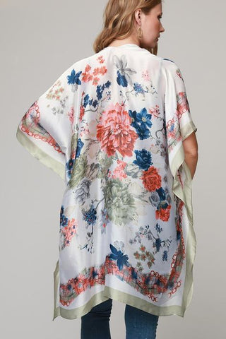 Woman wearing silky floral print kimono.