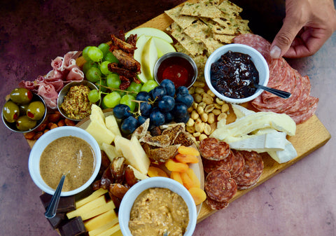 All-natural peanut butter and almond butter. Charcuterie board for mother's day. Party favorites for Mother's Day 2022. Cured meats, cheeses, dried fruit, fresh fruit.